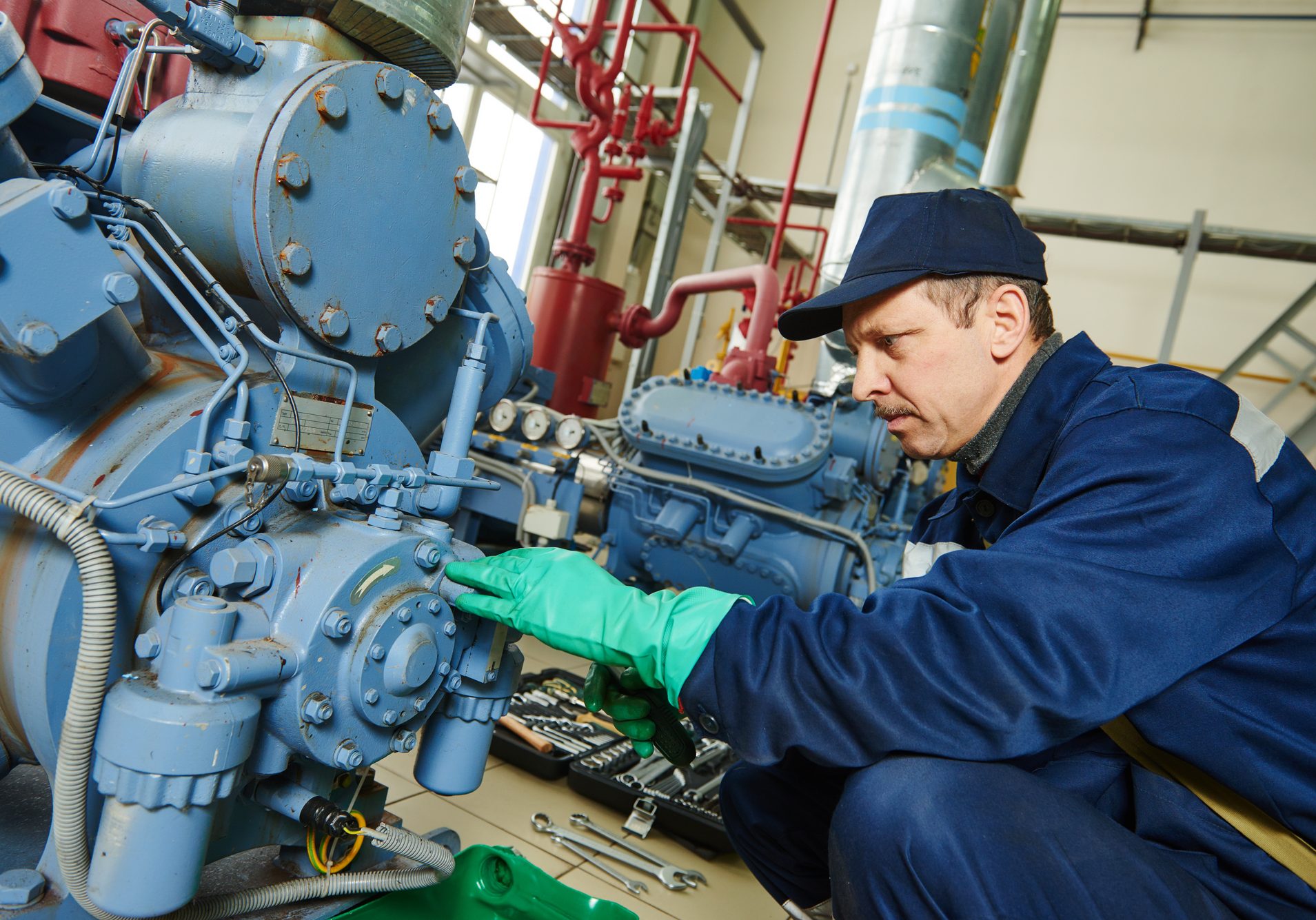 service worker at industrial compressor station